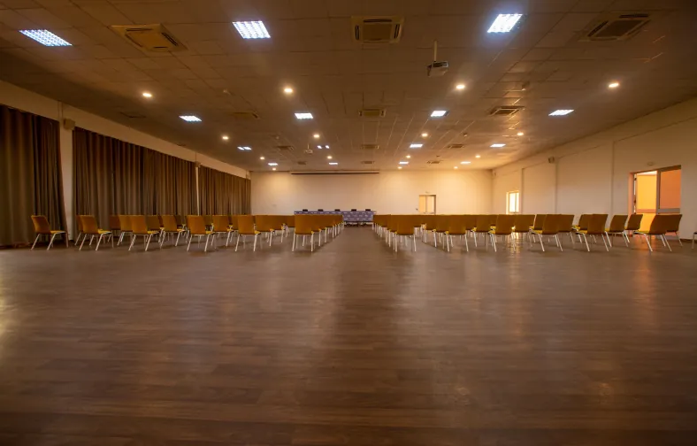 Grande salle de réunion, chaises jaunes en configuration théâtre